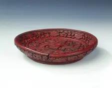 Carved red lacquer saucer with dragon amid clouds, Ming dynasty, China, late 16th century. Creator: Unknown