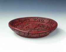 Carved red lacquer saucer with dragon amid clouds, Ming dynasty, China, late 16th century. Creator: Unknown
