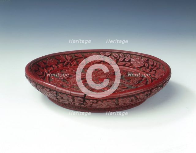 Carved red lacquer saucer with dragon amid clouds, Ming dynasty, China, late 16th century. Creator: Unknown.