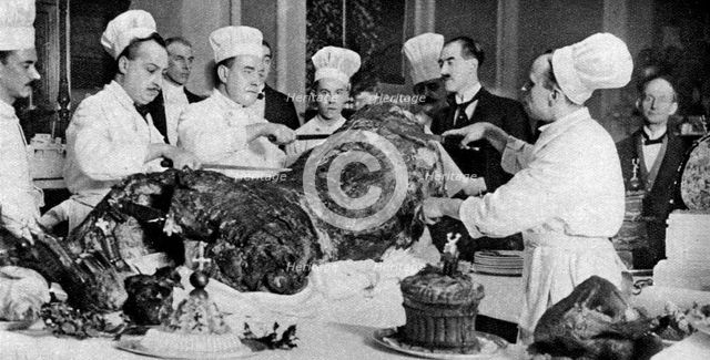 Carving a side of beef at the annual banquet at the Guildhall, London, 1926-1927. Artist: Unknown