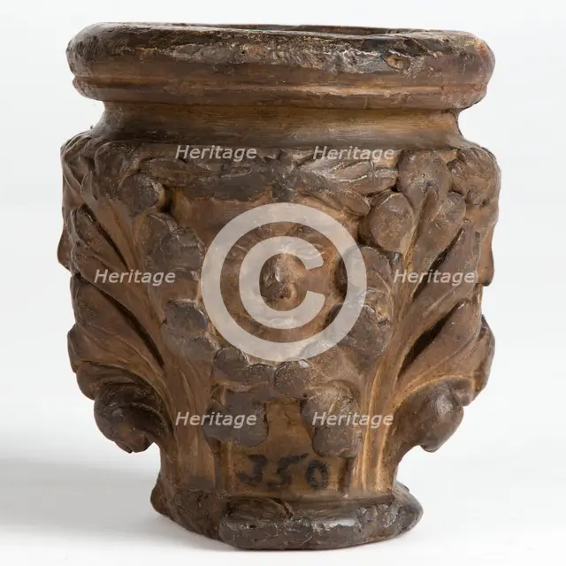 Cast of a medieval capital with leaf foliage and faces, possibly representing the Green Man, c1870. Creator: Unknown.