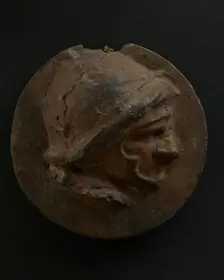 Cast of foreshortened head of Roman soldier in helmet. Creator: Unknown