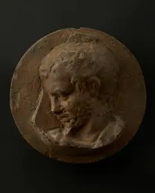 Cast of head of oarsman looking down, with vertical edge of building behind. Creator: Unknown