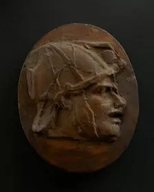 Cast of head of Eastern archer with helmet. Creator: Unknown
