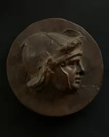 Cast of head of full-faced, young Roman soldier in helmet. Creator: Unknown