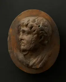 Cast of head of lightly-bearded man wearing wreath (?) and with mouth open. Creator: Unknown