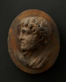 Cast of head of lightly-bearded man wearing wreath (?) and with mouth open. Creator: Unknown