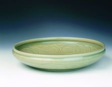Celadon dish with moulded tree and incised scrolls, Yuan-Ming dynasty, China, 14th century. Creator: Unknown