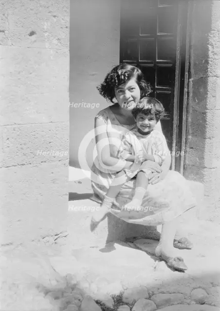 Cenerini, Mrs., and child, seated on a doorstep, 1929 Creator: Arnold Genthe.