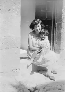 Cenerini, Mrs., and child, seated on a doorstep, 1929 Creator: Arnold Genthe