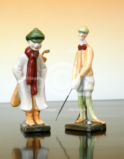 Ceramic figures of a golfer and caddy, Austrian, c1910. Creator: Unknown.