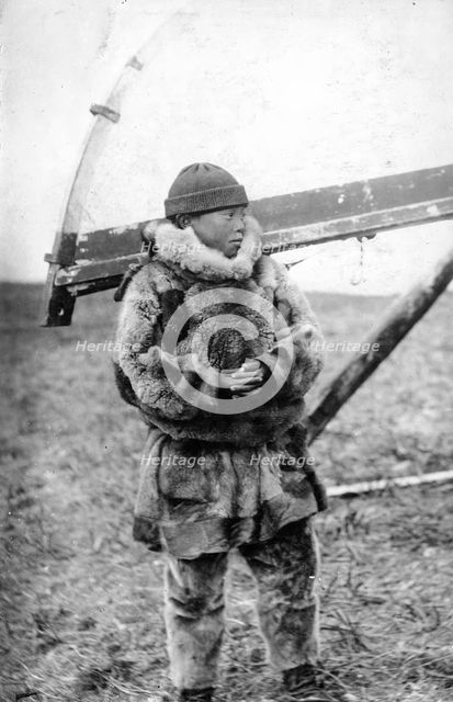 Chukchi boy in national clothes, kukhlyanka, fur pants, 1910-1929. Creator: Ivan Emelianovich Larin.
