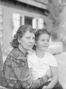 Churchill, Mrs., with child Orrin, seated outdoors, not before 1932 Mar. Creator: Arnold Genthe