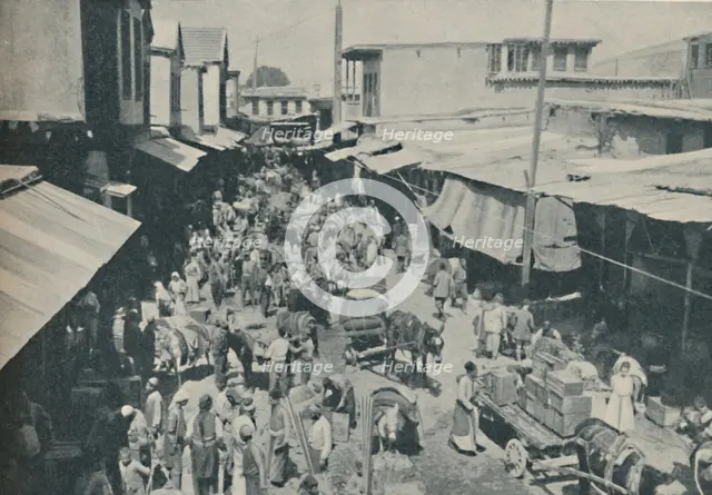 'Chaffering Oriental Crowds That Throng The Street Markets', c1935. Artist: Charles H Gabriel.