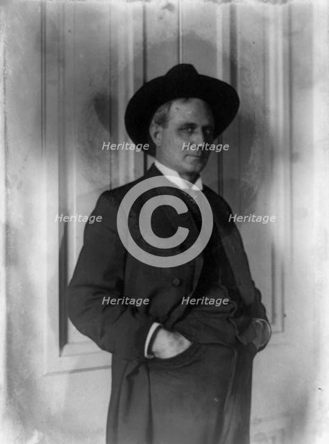 Champ Clark, half-length portrait, standing, facing right, hands in pants pockets, (1898?). Creator: Frances Benjamin Johnston.