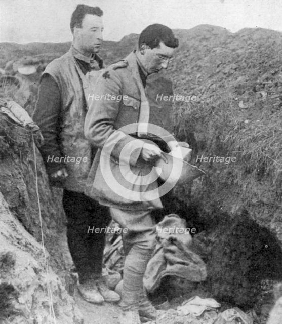 Chaplain of the lst Munsters saying a burial prayer over soldiers killed in their trench, 1918. Artist: Unknown