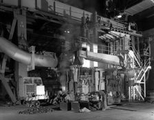 Charging an electric arc furnace, Park Gate Iron & Steel Co, Rotherham, South Yorkshire, 1964. Creator: Michael Walters