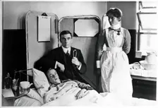 Charing Cross Hospital: Basil Hood with patient, 1904. Creator: Unknown