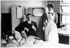 Charing Cross Hospital: Basil Hood with patient, 1904. Creator: Unknown
