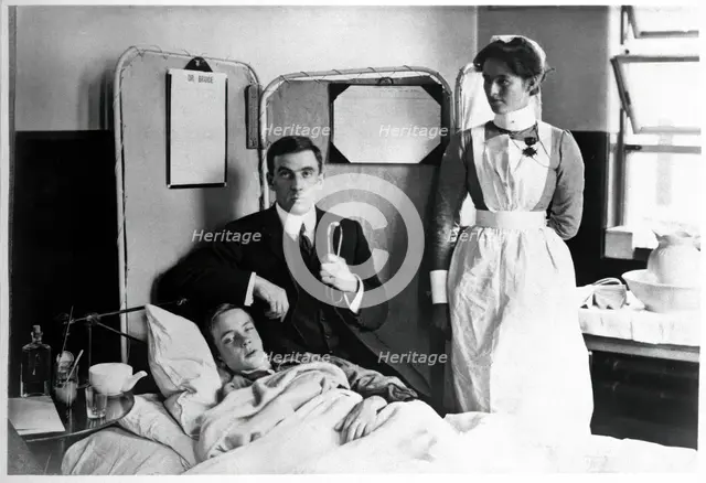 Charing Cross Hospital: Basil Hood with patient, 1904. Creator: Unknown.