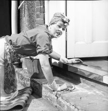 Charlady scrubbing steps, c1955. Creator: Arthur Charles Kirby Ware