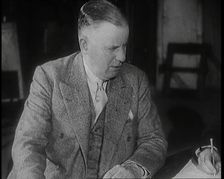 Charles B Cochran Sitting at a Table, 1920s. Creator: British Pathe Ltd