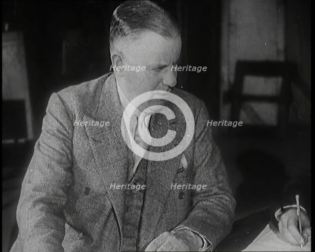 Charles B Cochran Sitting at a Table, 1920s. Creator: British Pathe Ltd.