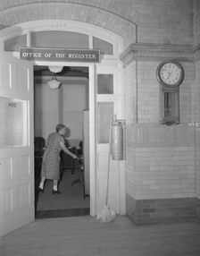 Charwoman cleaning after regular working hours at the Office...Treasury, Washington, D.C., 1942. Creator: Gordon Parks