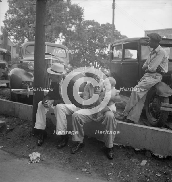 Chatham County farmers in town on Saturday afternoon, Pittsboro, North Carolina, 1939. Creator: Dorothea Lange.