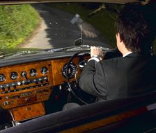 Chauffeur driving 1970 Daimler vanden plas DS 420 limousine