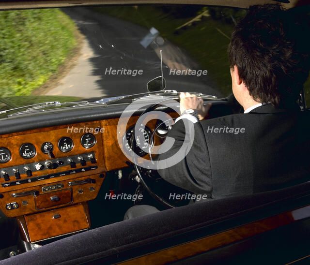 Chauffeur driving 1970 Daimler vanden plas DS 420 limousine. Artist: Unknown.