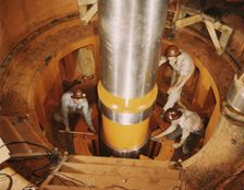 Checking the alignment of a turbine shaft at the top of the guide..., Watts Bar Dam, Tenn., 1942. Creator: Alfred T Palmer