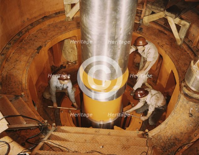 Checking the alignment of a turbine shaft at the top of the guide..., Watts Bar Dam, Tenn., 1942. Creator: Alfred T Palmer.