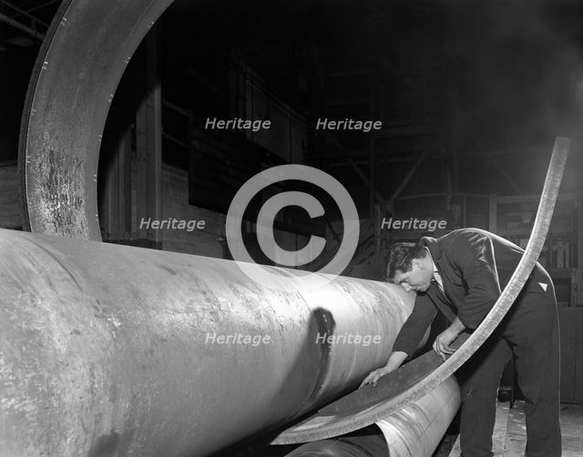 Checking the curve of a steel plate, Edgar Allen's steel foundry, Sheffield, Yorkshire, 1964.  Creator: Michael Walters.