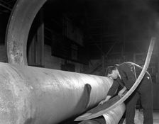 Checking the curve of a steel plate, Edgar Allen's steel foundry, Sheffield, Yorkshire, 1964. Creator: Michael Walters
