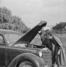 Checking the engine under the bonnet of an Opel Olympia, Landskrona, Sweden, 1959