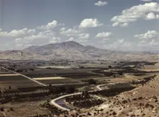 Cherry orchards, farm lands and irrigation ditch at Emmett, Idaho, 1941. Creator: Russell Lee