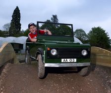 Child driving a toy Land Rover