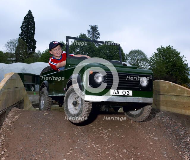 Child driving a toy Land Rover. Artist: Unknown.