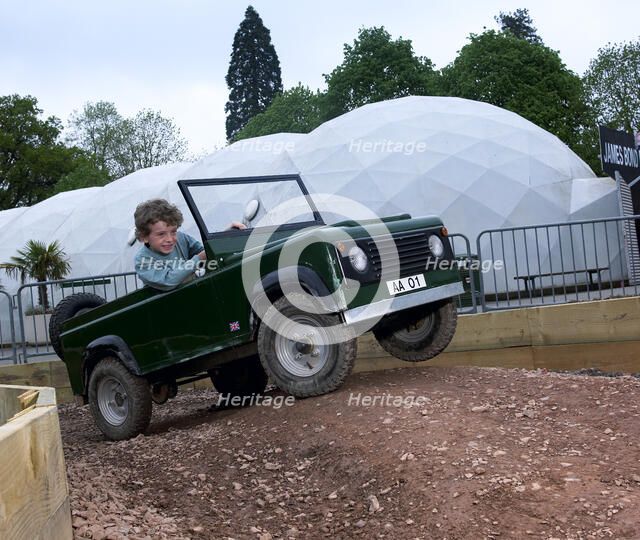 Child driving a toy Land Rover. Artist: Unknown.