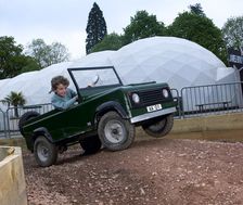Child driving a toy Land Rover