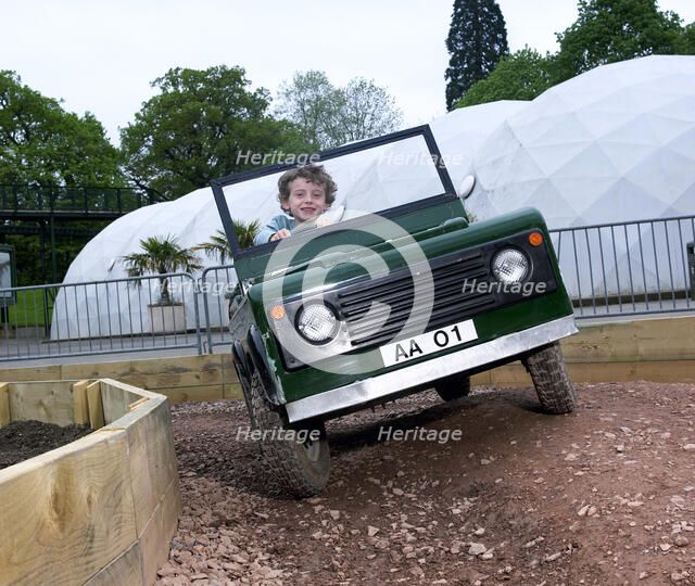 Child driving a toy Land Rover. Artist: Unknown.