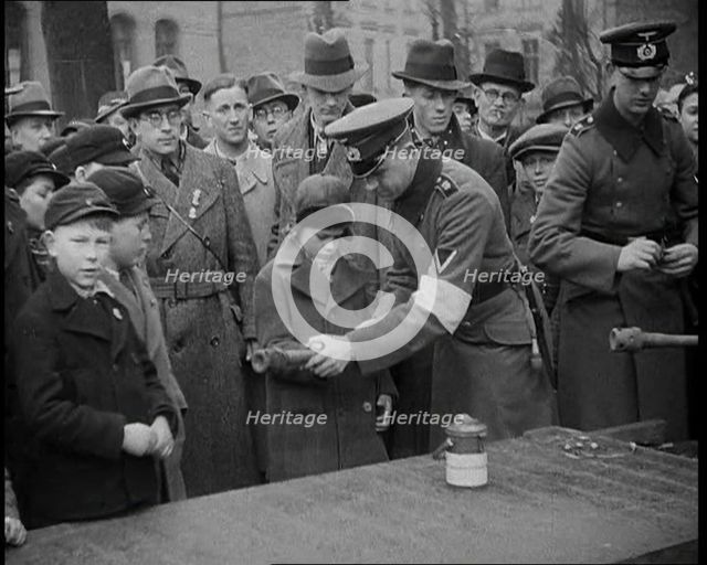 Child Holding a Hand Grenade, 1930s. Creator: British Pathe Ltd.
