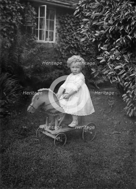 Child on a wooden horse, c1896-c1920. Artist: A Newton