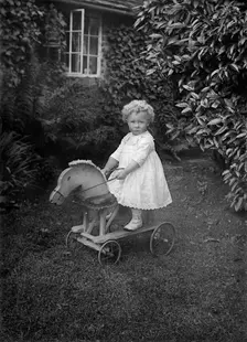 Child on a wooden horse, c1896-c1920. Artist: A Newton