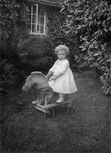 Child on a wooden horse, c1896-c1920. Artist: A Newton