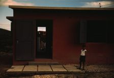 Child of an FSA - R.R. borrower? in front of their house, Puerto Rico, 1941 or 1942. Creator: Jack Delano