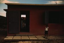 Child of an FSA - R.R. borrower? in front of their house, Puerto Rico, 1941 or 1942. Creator: Jack Delano