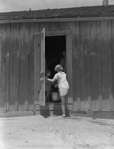 Child of Texas sharecropper carrying water, 1937. Creator: Dorothea Lange
