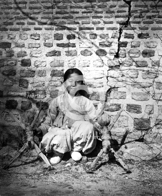 Child sitting by a wall, Korea, c1900. Artist: Unknown